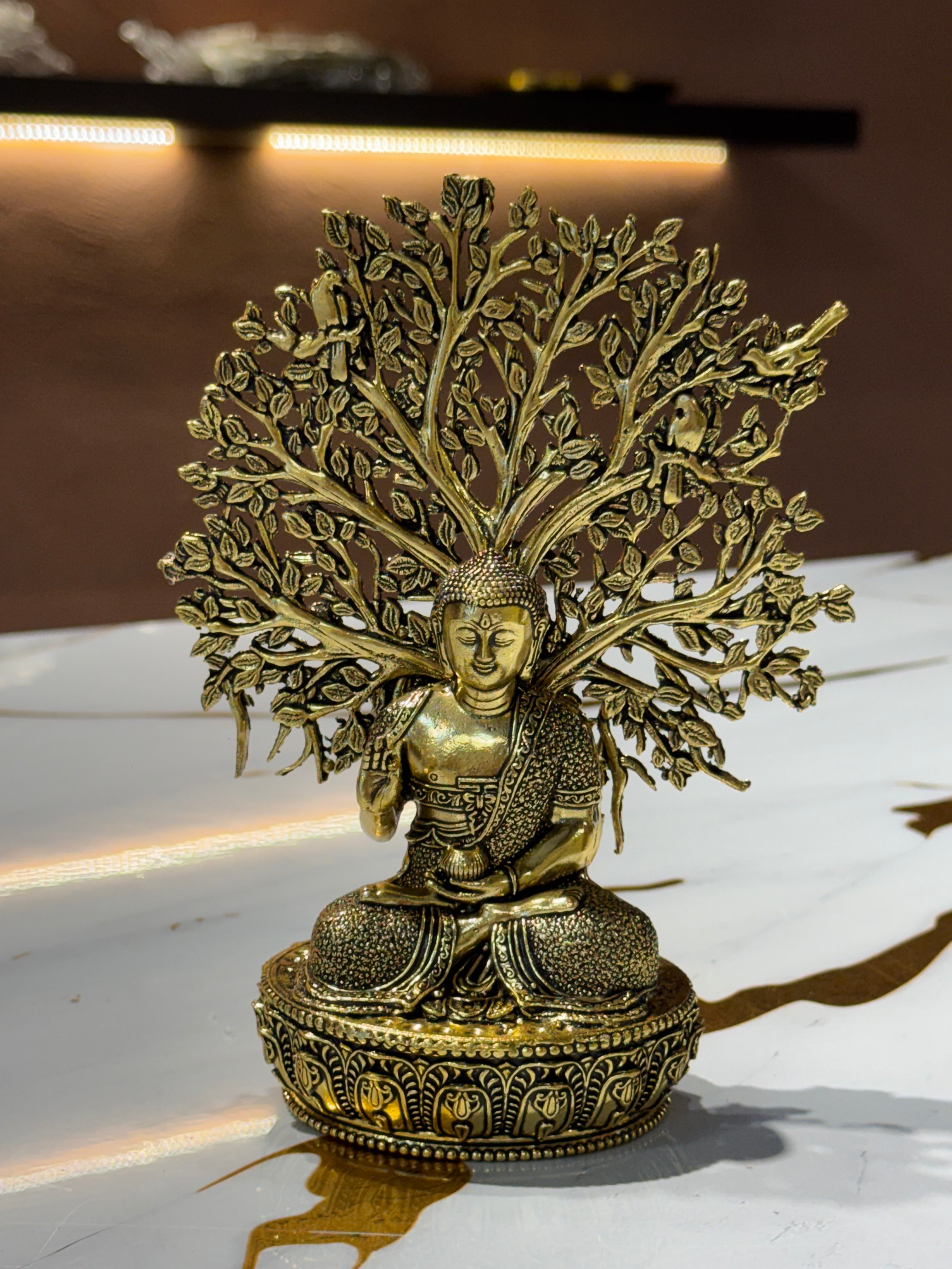Brass Buddha Statue under Bodhi Tree with Birds
