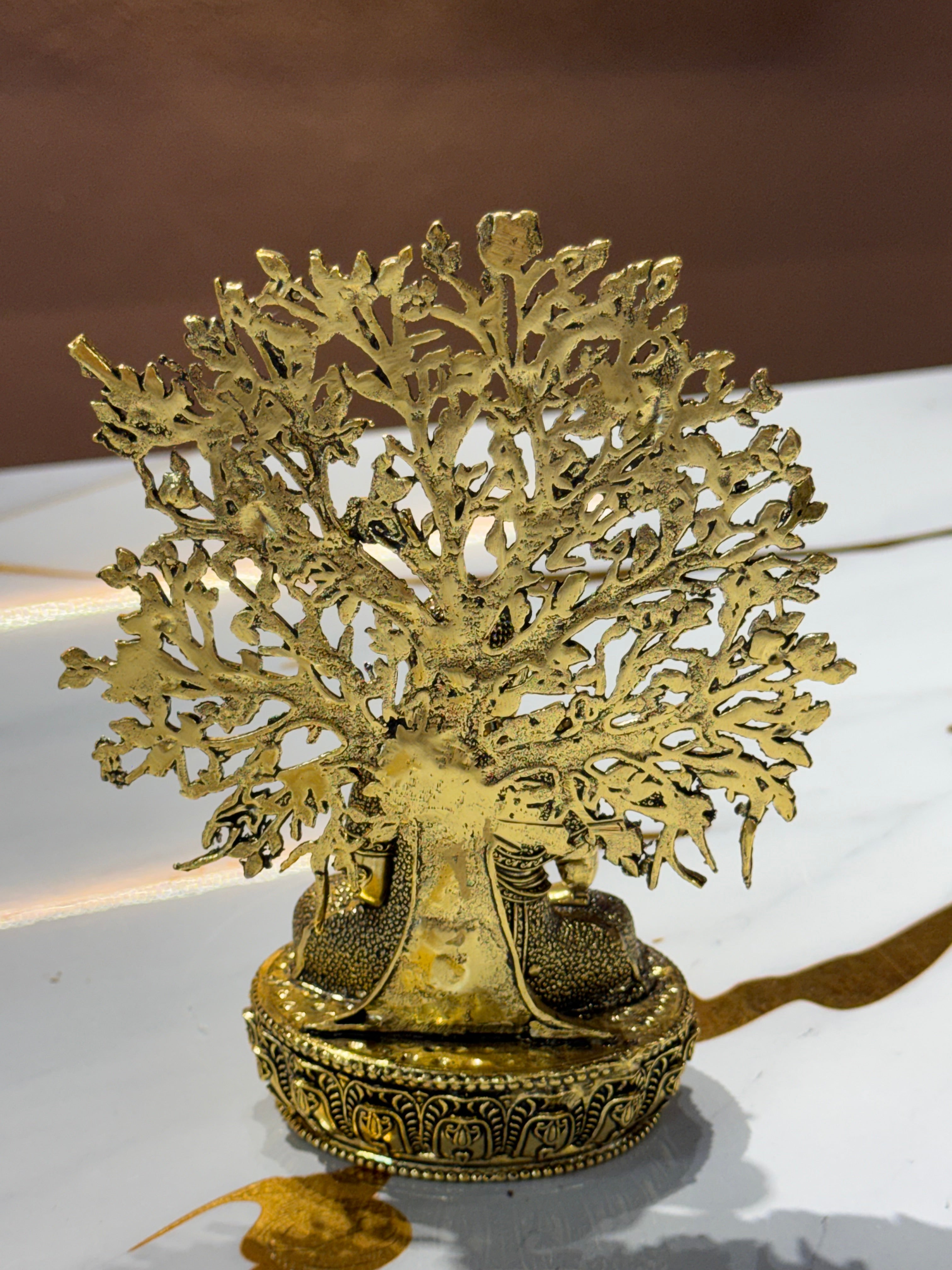 Brass Buddha Statue under Bodhi Tree with Birds