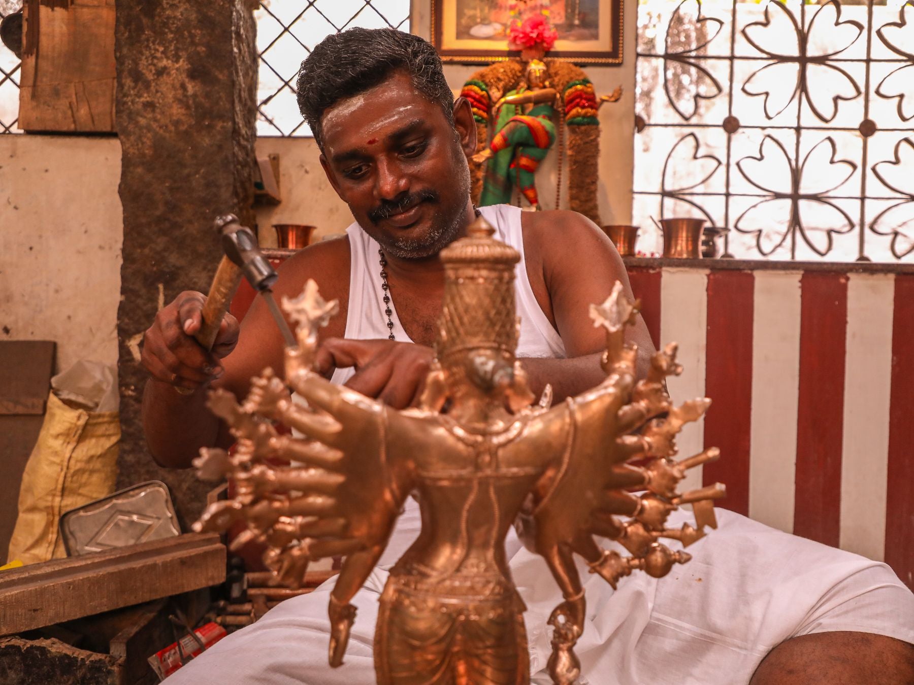 Artisan crafting a bronze deity statue in Kumbakonam, India