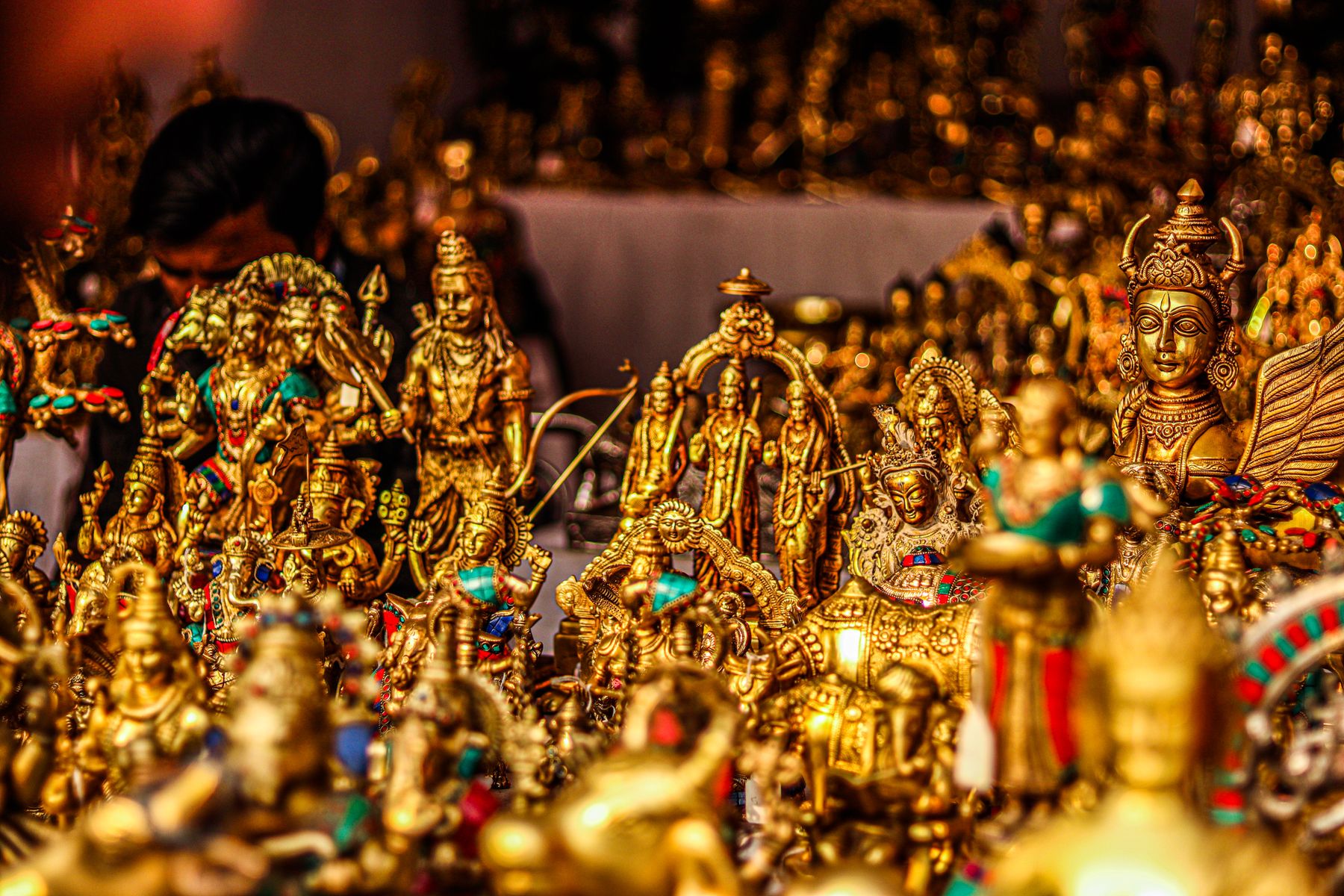 Collection of golden religious brass statues with traditional designs